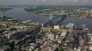 AX79_023 - 4.8K aerial stock footage of Benjamin Franklin Bridge spanning the Delaware River between Philadelphia, Pennsylvania and Camden, New Jersey