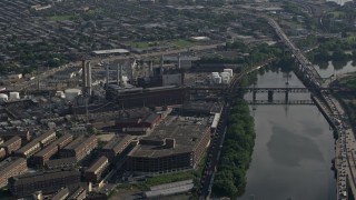 AX79_028 - 4.8K aerial stock footage of Veolia Energy power plant next to the Schuylkill River Philadelphia, Pennsylvania