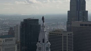 AX79_038 - 4.8K aerial stock footage approaching William Penn statue on Philadelphia City Hall, Downtown Philadelphia, Pennsylvania