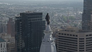 AX79_039 - 4.8K stock footage aerial video of the William Penn statue on Philadelphia City Hall, Downtown Philadelphia, Pennsylvania