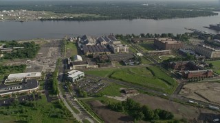 AX79_080 - 4.8K aerial stock footage of factory buildings at The Navy Yard by the Delaware River, Pennsylvania