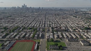 AX79_084 - 4.8K aerial stock footage flying over South Philadelphia neighborhoods with a view of the downtown skyline, Pennsylvania