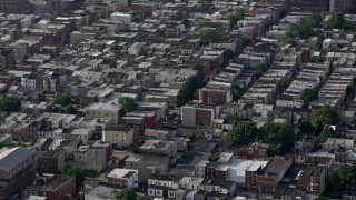 AX79_086E - 4.8K aerial stock footage of urban neighborhood and busy street in South Philadelphia, Pennsylvania