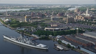 AX79_088E - 4.8K aerial stock footage approaching USS New Jersey on Delaware River, BB&T Pavilion, and Balzano Marine Terminal, Camden, New Jersey