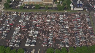AX79_094 - 4.8K aerial stock footage of crowds in a parking lot near Campbell's Field, Camden, New Jersey