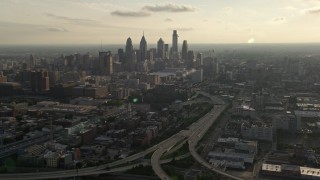 AX80_004 - 4.8K aerial stock footage of I-676 to Downtown Philadelphia skyline, Pennsylvania, Sunset