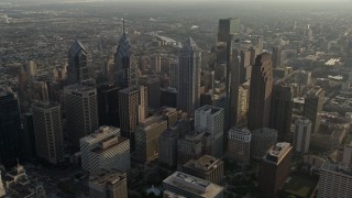 AX80_007E - 4.8K aerial stock footage approaching Downtown Philadelphia's City Hall and tall skyscrapers, Pennsylvania, Sunset