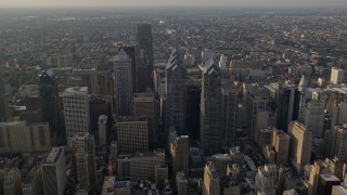 AX80_011E - 4.8K aerial stock footage of Downtown Philadelphia skyscrapers, city buildings and urban neighborhoods in Pennsylvania, Sunset