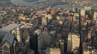 AX80_023E - 4.8K aerial stock footage flying by office and apartment buildings, reveal City Hall, Downtown Philadelphia, Pennsylvania, Sunset