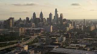AX80_031 - 4.8K aerial stock footage of Downtown Philadelphia skyline and Pennsylvania Convention Center at Sunset