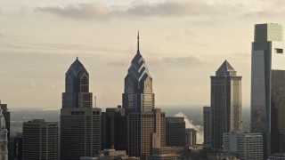 AX80_032 - 4.8K aerial stock footage of rooftops of One and Two Liberty Place, Philadelphia, Pennsylvania, Sunset