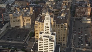 AX80_047 - 4.8K aerial stock footage of the Inquirer Building clock tower in Downtown Philadelphia, Pennsylvania, Sunset
