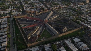 AX80_051 - 4.8K aerial stock footage flying by Eastern State Penitentiary in Philadelphia, Pennsylvania at Sunset