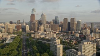 AX80_056 - 4.8K aerial stock footage approaching Philadelphia City Hall and skyscrapers in Downtown Philadelphia, Pennsylvania, Sunset