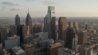 AX80_061 - 4.8K aerial stock footage flying by Downtown Philadelphia skyscrapers, Pennsylvania, Sunset