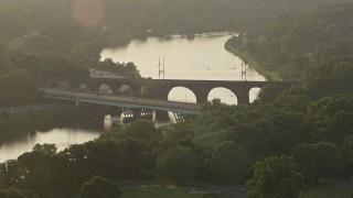 AX80_064 - 4.8K aerial stock footage of Girard Bridge spanning the Schuylkill River, Philadelphia, Pennsylvania, Sunset