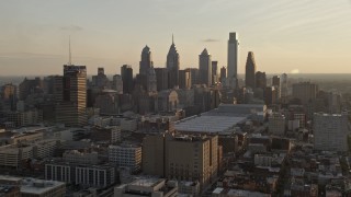 AX80_078E - 4.8K aerial stock footage approaching the Downtown Philadelphia skyline and convention center in Pennsylvania, Sunset
