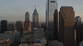 AX80_081E - 4.8K aerial stock footage flying by Downtown Philadelphia's tall skyscrapers, Pennsylvania, Sunset
