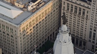 AX80_096 - 4.8K aerial stock footage of the William Penn statue on top of Philadelphia City Hall, Pennsylvania, Sunset