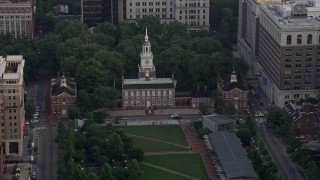 AX80_100 - 4.8K aerial stock footage approaching Old City Hall and Independence Hall, Downtown Philadelphia, Pennsylvania, Sunset