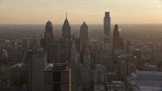AX80_101 - 4.8K aerial stock footage approaching City Hall and Downtown Philadelphia skyscrapers, Pennsylvania, Sunset