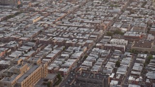 AX80_109E - 4.8K aerial stock footage of an urban neighborhood in South Philadelphia, Pennsylvania, Sunset
