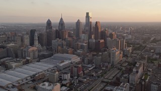 AX80_117E - 4.8K aerial stock footage of Downtown Philadelphia skyscrapers and Pennsylvania Convention Center, Sunset
