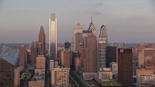 AX80_124E - 4.8K aerial stock footage flying by Downtown Philadelphia skyline, reveal Cira Centre, Pennsylvania, Sunset