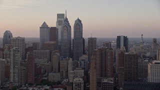 AX80_129 - 4.8K aerial stock footage flying by Downtown Philadelphia skyscrapers and City Hall, Pennsylvania, Sunset