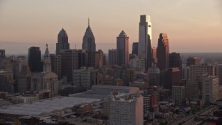 AX80_142 - 4.8K aerial stock footage approaching tall skyscrapers in Downtown Philadelphia, Pennsylvania, Sunset