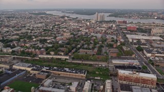 AX80_145 - 4.8K aerial stock footage of row houses by railroad tracks and Edgar Allan Poe House in North Philadelphia, Pennsylvania, Sunset