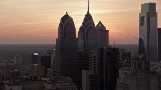 AX80_157 - 4.8K aerial stock footage of One and Two Liberty Place in Downtown Philadelphia, Pennsylvania, Sunset