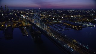 AX81_004 - 4.8K aerial stock footage flying by Benjamin Franklin Bridge, reveal Downtown Philadelphia skyline, Pennsylvania, Night
