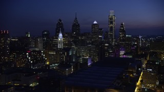 AX81_013E - 4.8K aerial stock footage of Downtown Philadelphia skyscrapers, city hall, and Pennsylvania Convention Center, Pennsylvania, Night