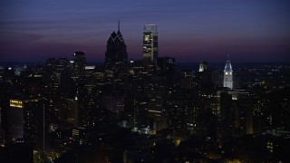 AX81_017E - 4.8K aerial stock footage flying by skyscrapers near city hall in Downtown Philadelphia, Pennsylvania, Night