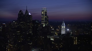 AX81_019 - 4.8K aerial stock footage of Downtown Philadelphia's tall skyscrapers and the City Hall clock tower, Pennsylvania, Night