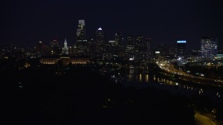 AX81_028 - 4.8K aerial stock footage of Downtown Philadelphia skyline behind the Philadelphia Museum of Art and the Schuylkill River, Pennsylvania, Night