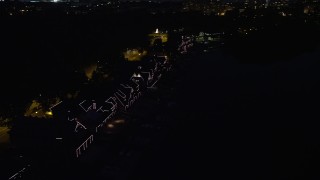 AX81_029 - 4.8K aerial stock footage of Boathouse Row with lights at night in Philadelphia, Pennsylvania