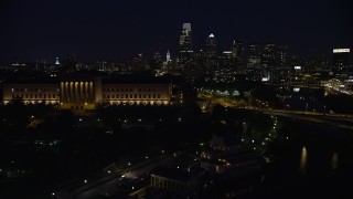 AX81_030 - 4.8K stock footage aerial video flying by Philadelphia Museum of Art and approach Downtown Philadelphia skyline, Pennsylvania, Night