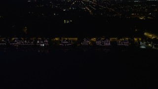 AX81_033 - 4.8K aerial stock footage of Boathouse Row by the Schuylkill River at night in Philadelphia, Pennsylvania