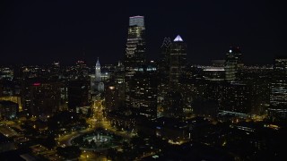 AX81_036E - 4.8K aerial stock footage following Benjamin Franklin Parkway toward City Hall and Downtown Philadelphia skyline, Pennsylvania, Night