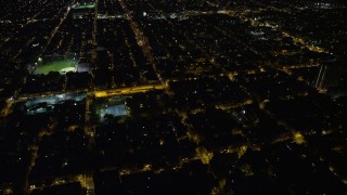 AX81_043 - 4.8K aerial stock footage of urban neighborhoods and baseball fields in South Philadelphia, Pennsylvania, Night