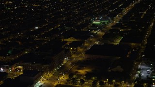 AX81_044 - 4.8K aerial stock footage of city streets and dark warehouse building in South Philadelphia, Pennsylvania, Night