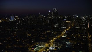 AX81_045 - 4.8K aerial stock footage of Downtown Philadelphia skyline and Broad Street leading to City Hall, Pennsylvania, Night