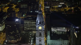 AX81_047E - 4.8K aerial stock footage approaching Philadelphia City Hall, tilt to bird's eye view, Pennsylvania Night