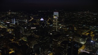 AX81_064 - 4.8K stock footage aerial video flying over Downtown Philadelphia's tall skyscrapers to reveal Philadelphia Museum of Art, Pennsylvania, Night