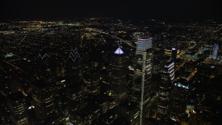AX81_068E - 4.8K aerial stock footage flying by City Hall and over Downtown Philadelphia's skyscrapers, Pennsylvania, Night