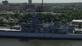 AX82_001 - 4.8K aerial stock footage flying by the battleship USS New Jersey, Camden, New Jersey