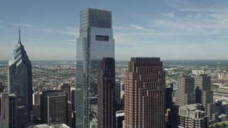AX82_017 - 4.8K aerial stock footage of Comcast Center and Three Logan Square in Downtown Philadelphia, Pennsylvania