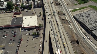 AX82_027 - 4.8K aerial stock footage tilting from Interstate 95 with light traffic to reveal industrial buildings in North Philadelphia, Pennsylvania